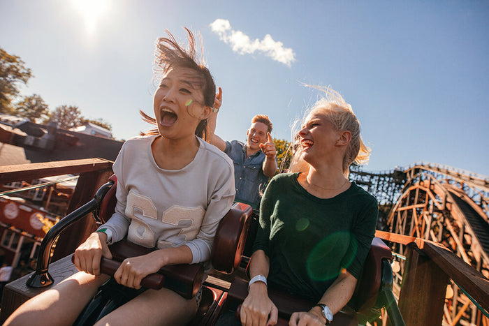 Friends laughing on a rollercoaster