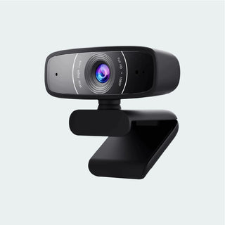 A black web camera with a clip-on stand, featuring a glossy finish and a prominent multi-colored lens, shown against a light gray background.